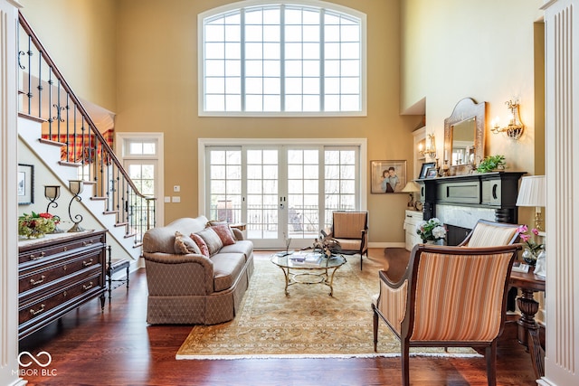 4636 S Hawks Way, Bloomington, IN 47401 - living area with healthy amount of natural light, wood finished floors, stairs, and a high ceiling
