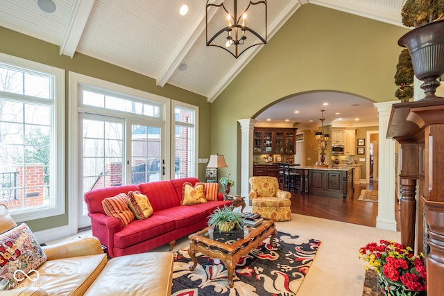 4636 S Hawks Way, Bloomington, IN 47401 - living area featuring ornate columns, arched walkways, healthy amount of natural light, beam ceiling, and a chandelier