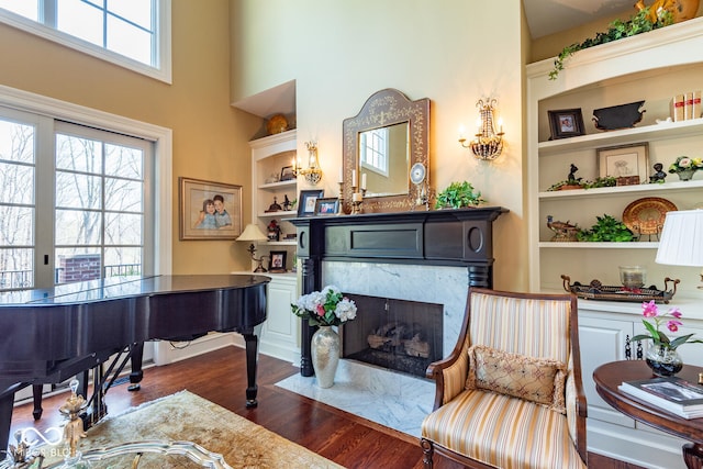 4636 S Hawks Way, Bloomington, IN 47401 - office space featuring dark wood finished floors, built in shelves, a towering ceiling, and a high end fireplace