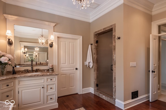 4636 S Hawks Way, Bloomington, IN 47401 - bathroom featuring a chandelier, a stall shower, wood finished floors, vanity, and ornamental molding