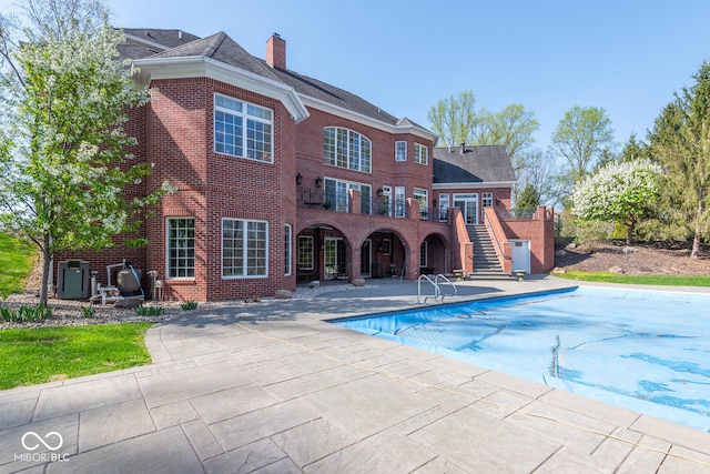4636 S Hawks Way, Bloomington, IN 47401 - view of pool featuring a patio area, stairs, and a covered pool