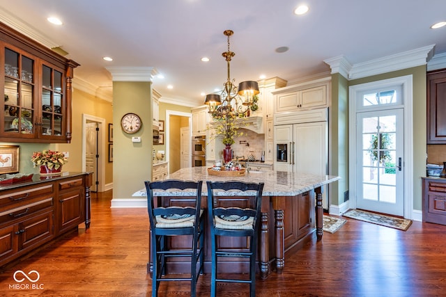 4636 S Hawks Way, Bloomington, IN 47401 - kitchen with a chandelier, light stone countertops, glass insert cabinets, dark wood-type flooring, and ornamental molding