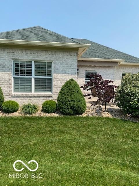 3354 Nottinghill Dr, Plainfield, IN 46168 - view of side of property with brick siding, a shingled roof, and a yard