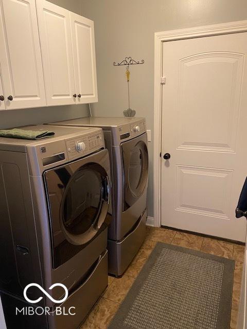 3354 Nottinghill Dr, Plainfield, IN 46168 - washroom featuring cabinet space, washer and dryer, and light tile patterned flooring