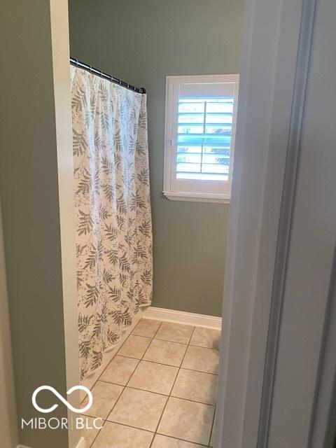 3354 Nottinghill Dr, Plainfield, IN 46168 - bathroom featuring tile patterned floors and a shower with shower curtain
