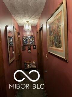 241 Deborah Ln, Whiteland, IN 46184 - hallway featuring a textured ceiling and arched walkways