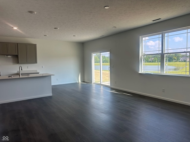 7909 Magnolia St, New Palestine, IN 46163 - unfurnished living room with a textured ceiling, dark wood-style floors, and recessed lighting