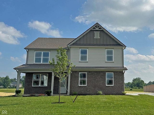 7909 Magnolia St, New Palestine, IN 46163 - view of front facade with brick siding, a front lawn, and board and batten siding