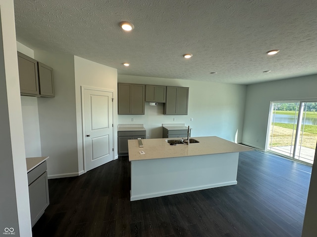 7909 Magnolia St, New Palestine, IN 46163 - kitchen with gray cabinets, dark wood-style floors, an island with sink, recessed lighting, and a textured ceiling