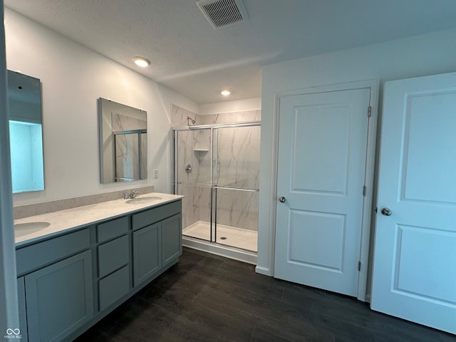7909 Magnolia St, New Palestine, IN 46163 - bathroom featuring a marble finish shower, double vanity, wood finished floors, and recessed lighting