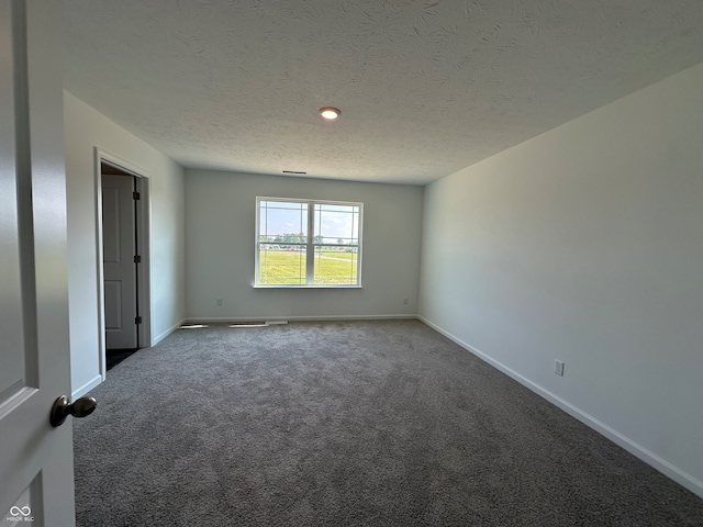 7909 Magnolia St, New Palestine, IN 46163 - unfurnished room featuring carpet floors and a textured ceiling