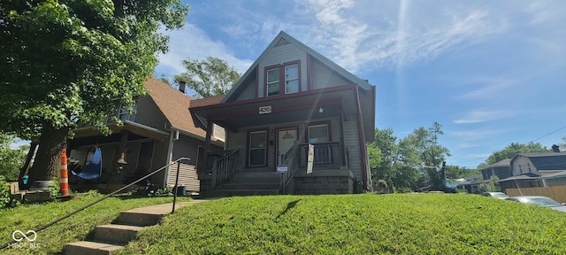 435 N Rural St NE, Indianapolis, IN 46201 - bungalow-style home featuring covered porch and a front yard