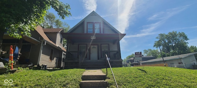 435 N Rural St NE, Indianapolis, IN 46201 - view of front of house featuring covered porch and a front yard
