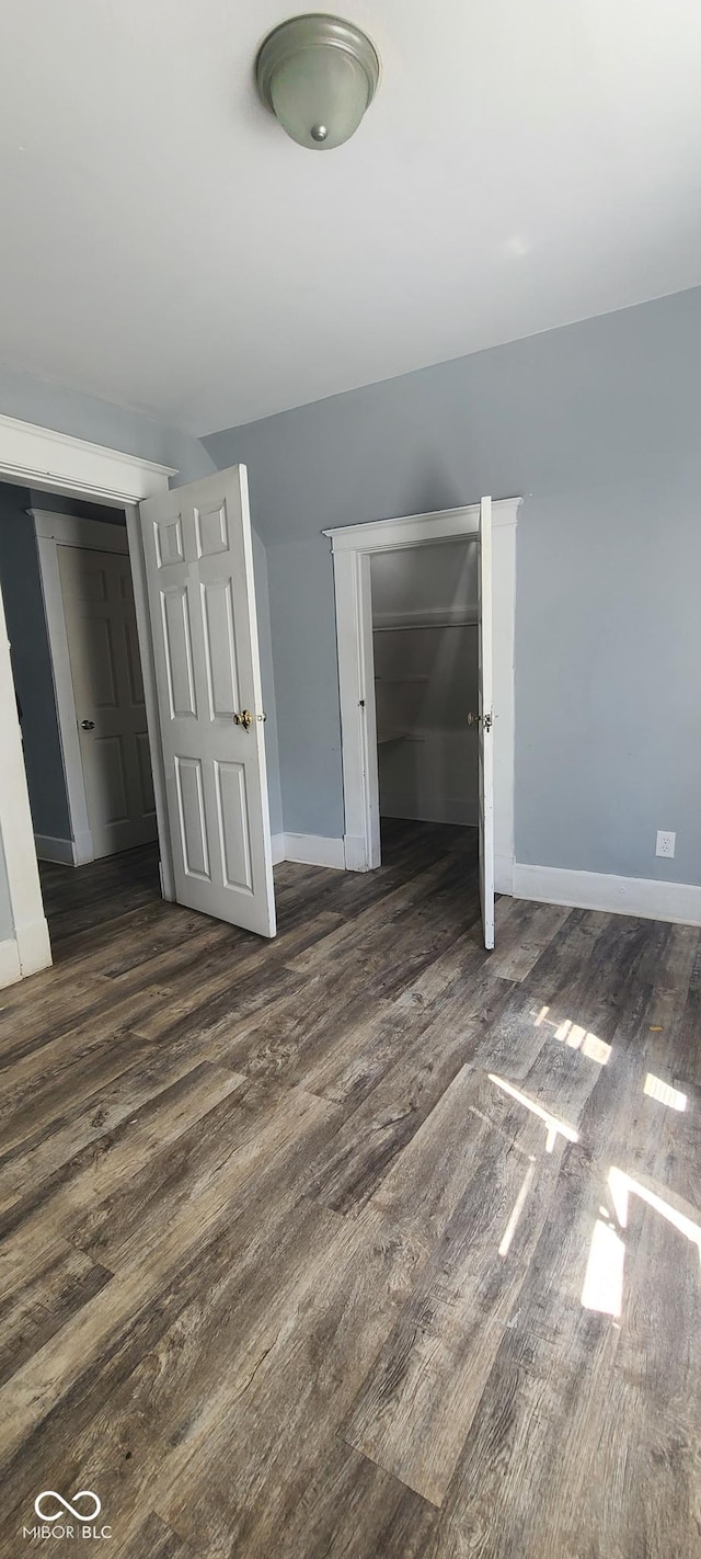 435 N Rural St NE, Indianapolis, IN 46201 - unfurnished bedroom with dark wood-type flooring