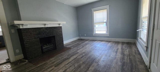 435 N Rural St NE, Indianapolis, IN 46201 - unfurnished living room featuring a fireplace and dark wood finished floors