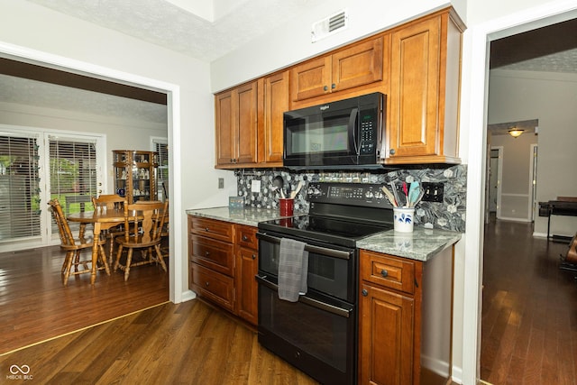 13 Fairlane Dr, Brownsburg, IN 46112 - kitchen featuring black appliances, dark wood finished floors, backsplash, a textured ceiling, and light stone counters