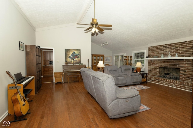 13 Fairlane Dr, Brownsburg, IN 46112 - living room with a textured ceiling, a ceiling fan, wood finished floors, vaulted ceiling, and a brick fireplace