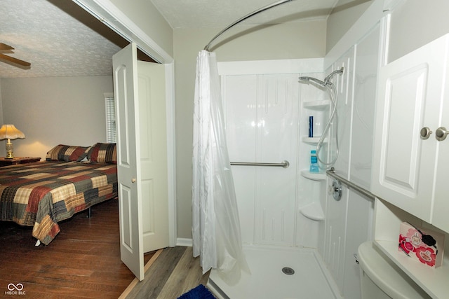 13 Fairlane Dr, Brownsburg, IN 46112 - full bathroom featuring wood finished floors, a shower with curtain, a textured ceiling, and connected bathroom
