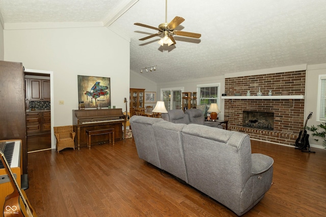 13 Fairlane Dr, Brownsburg, IN 46112 - living area with a ceiling fan, wood finished floors, a textured ceiling, a brick fireplace, and beamed ceiling