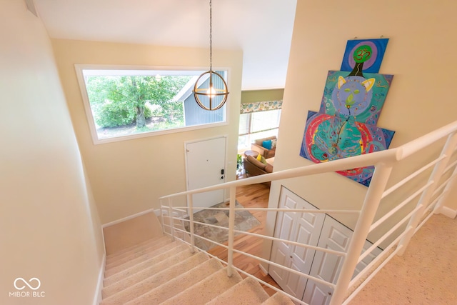 2608 S Trotters Run, Bloomington, IN 47401 - staircase featuring baseboards and a chandelier