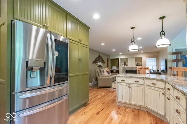 2608 S Trotters Run, Bloomington, IN 47401 - kitchen with stainless steel fridge, green cabinets, light wood-style flooring, open floor plan, and hanging light fixtures