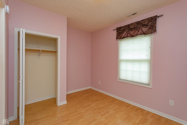 3631 Senior Pl, West Lafayette, IN 47906 - unfurnished bedroom featuring light wood finished floors, a textured ceiling, and a closet