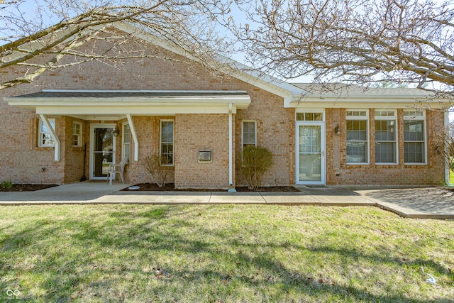 3631 Senior Pl, West Lafayette, IN 47906 - rear view of property featuring brick siding, a yard, and a patio