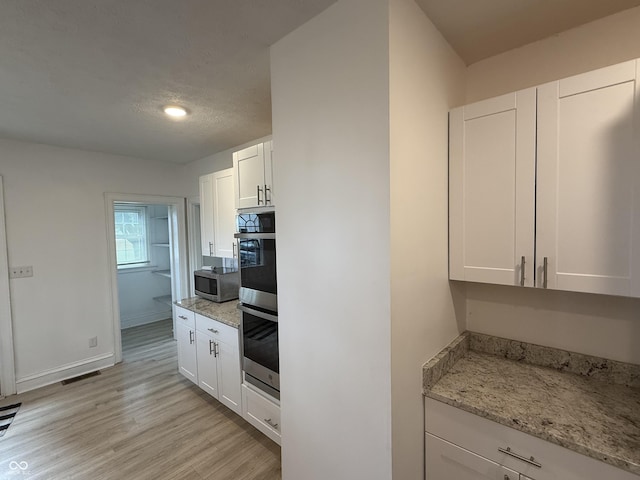 2607 N Henderson Rd, Rushville, IN 46173 - kitchen featuring stainless steel appliances, light wood-style floors, white cabinetry, light stone countertops, and recessed lighting