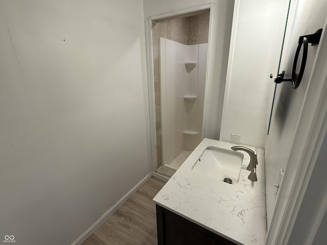 2607 N Henderson Rd, Rushville, IN 46173 - full bathroom with vanity, a shower stall, and wood finished floors