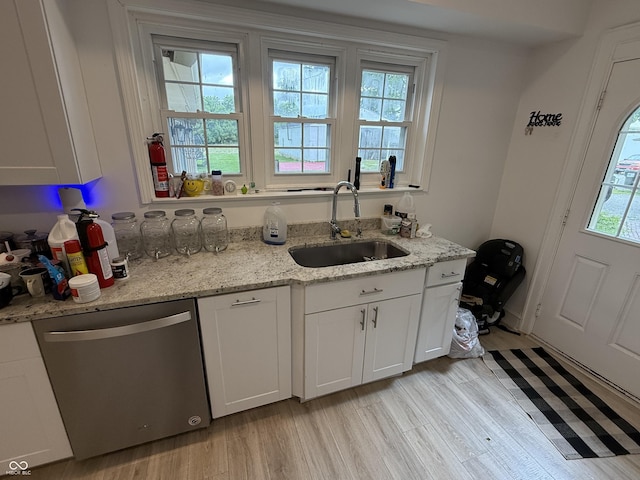 2607 N Henderson Rd, Rushville, IN 46173 - kitchen with stainless steel dishwasher, light wood-style flooring, white cabinets, and light stone counters