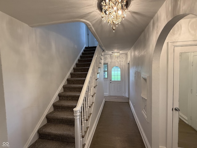 2607 N Henderson Rd, Rushville, IN 46173 - stairway featuring arched walkways, wood finished floors, and a chandelier