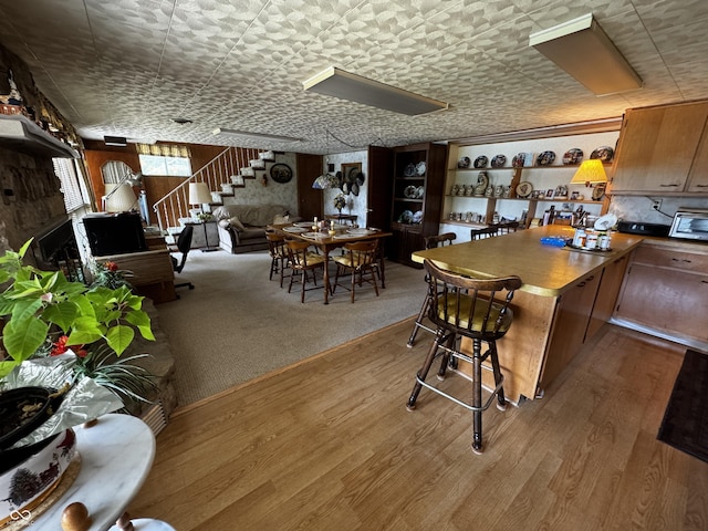 8664 S Nash Dr, Nineveh, IN 46164 - kitchen with wood finished floors, a breakfast bar area, and a peninsula