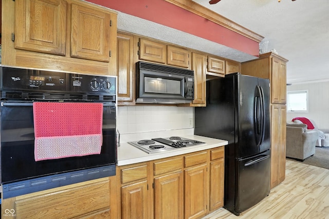 7113 Chandler Dr, Indianapolis, IN 46217 - kitchen with black appliances, tasteful backsplash, ornamental molding, light countertops, and light wood-type flooring