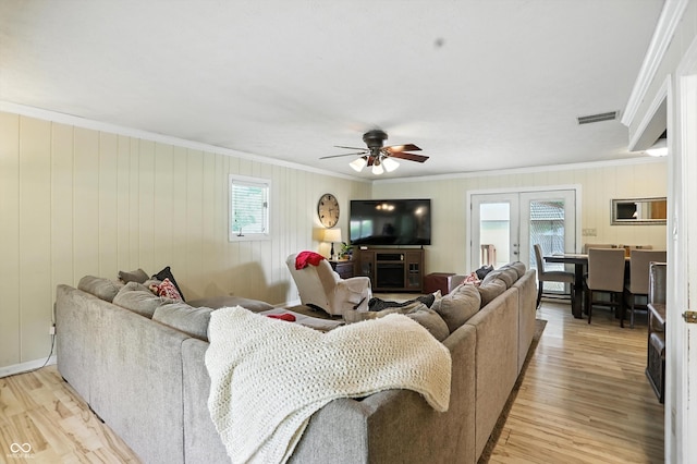 7113 Chandler Dr, Indianapolis, IN 46217 - living area featuring a ceiling fan, plenty of natural light, light wood-style flooring, and crown molding