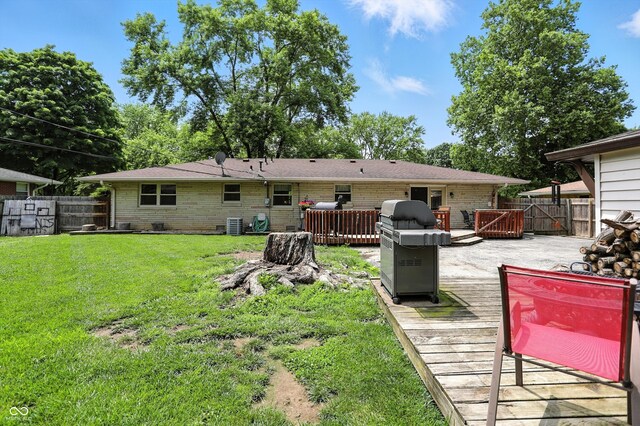 7113 Chandler Dr, Indianapolis, IN 46217 - back of house featuring a deck and brick siding