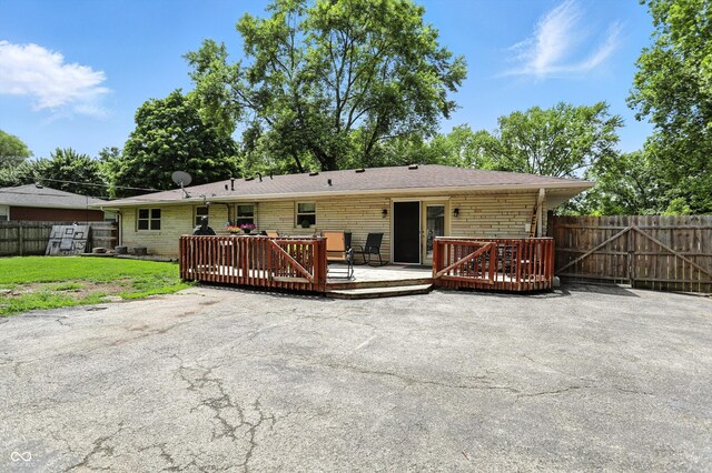 7113 Chandler Dr, Indianapolis, IN 46217 - rear view of property with a wooden deck and brick siding