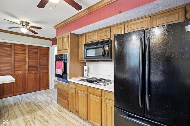 7113 Chandler Dr, Indianapolis, IN 46217 - kitchen with black appliances, a ceiling fan, light countertops, backsplash, and crown molding