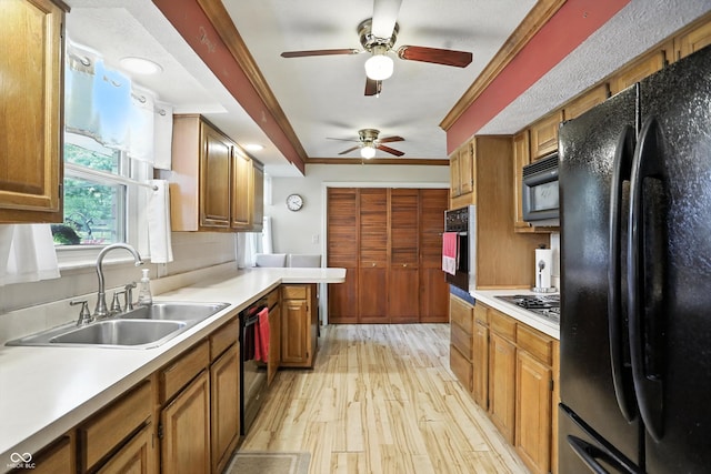 7113 Chandler Dr, Indianapolis, IN 46217 - kitchen featuring black appliances, a ceiling fan, light wood-type flooring, light countertops, and ornamental molding