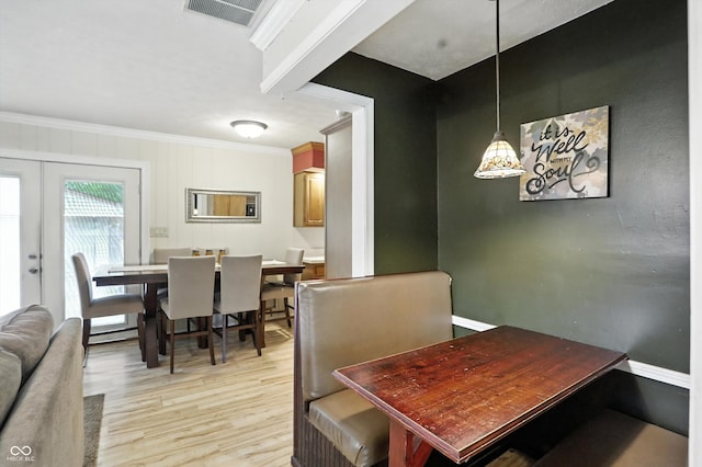 7113 Chandler Dr, Indianapolis, IN 46217 - dining area with light wood-type flooring, crown molding, and french doors