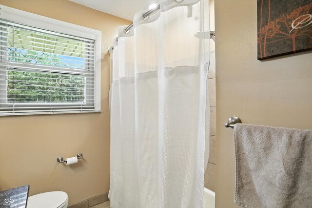 7113 Chandler Dr, Indianapolis, IN 46217 - full bathroom featuring toilet and shower / bath combo
