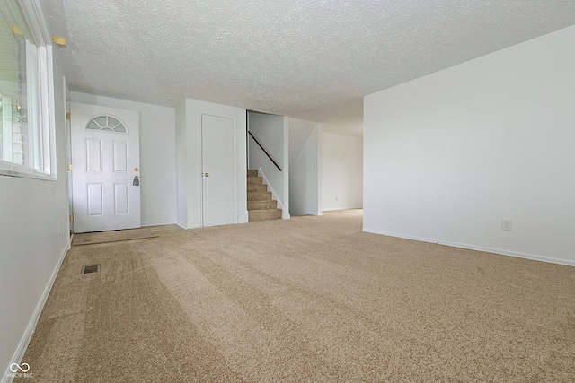 1217 S Post Rd, Indianapolis, IN 46239 - carpeted empty room with stairs and a textured ceiling