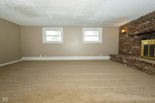 1217 S Post Rd, Indianapolis, IN 46239 - unfurnished living room with healthy amount of natural light, carpet, a textured ceiling, and a fireplace
