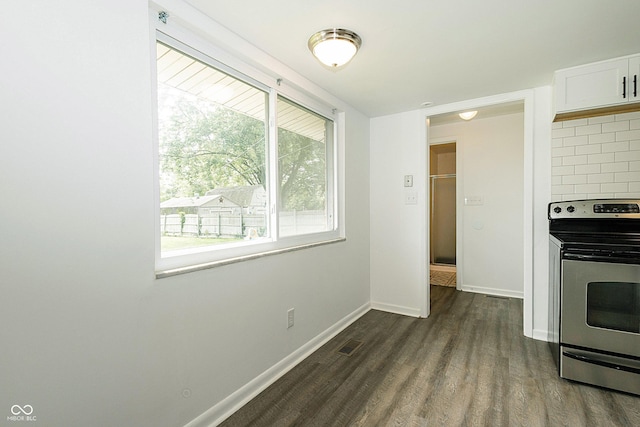 1217 S Post Rd, Indianapolis, IN 46239 - kitchen with stainless steel range with electric stovetop, dark wood-type flooring, white cabinetry, and decorative backsplash