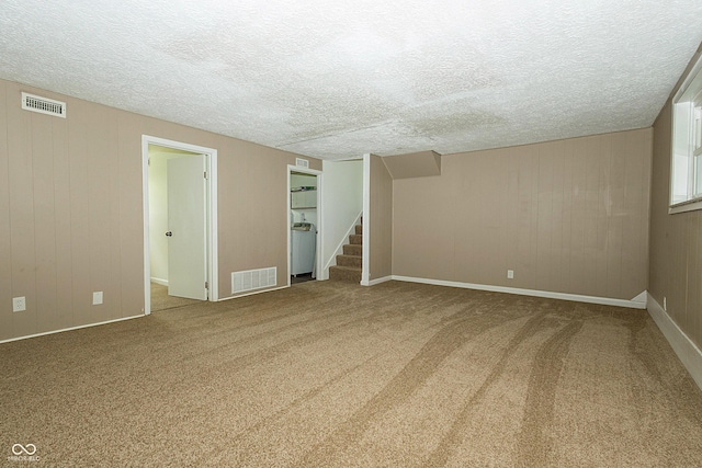 1217 S Post Rd, Indianapolis, IN 46239 - carpeted spare room with stairway, a textured ceiling, and wood walls