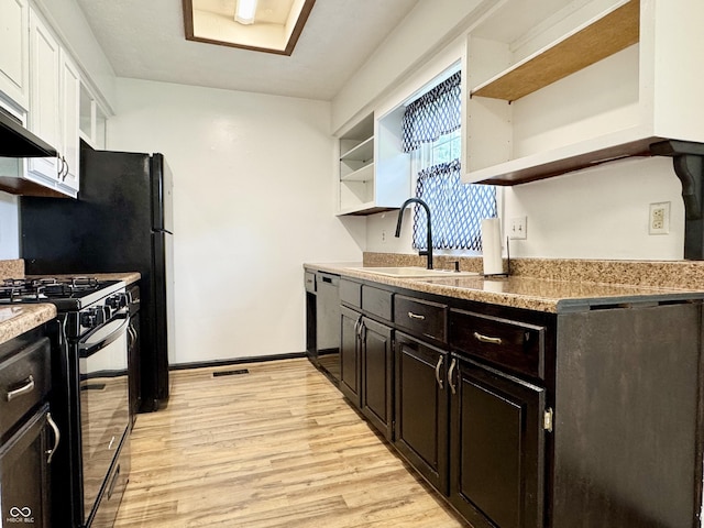 100 Justin Dr, Mooresville, IN 46158 - kitchen with open shelves, black range with gas stovetop, dishwasher, and light wood-style floors