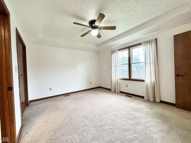 100 Justin Dr, Mooresville, IN 46158 - unfurnished room featuring light carpet, a raised ceiling, a ceiling fan, and a textured ceiling