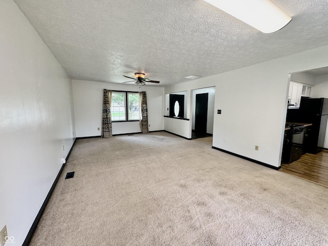 100 Justin Dr, Mooresville, IN 46158 - unfurnished living room with ceiling fan, light carpet, and a textured ceiling