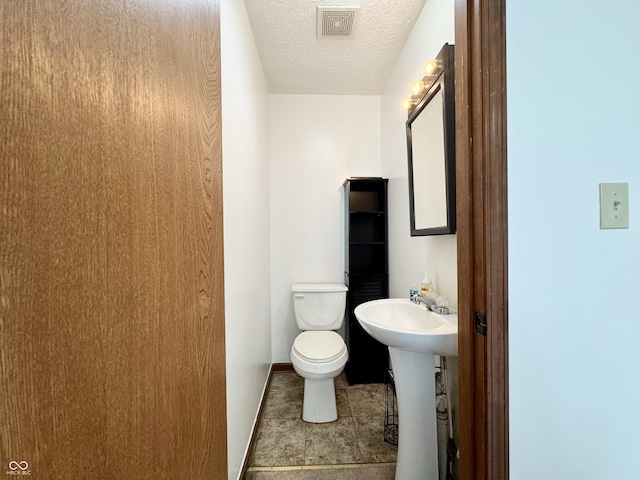 100 Justin Dr, Mooresville, IN 46158 - half bath featuring a textured ceiling and tile patterned floors