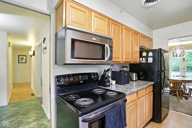 4340 Ashbourne Ln, Indianapolis, IN 46226 - kitchen with black appliances, light brown cabinetry, and light stone countertops