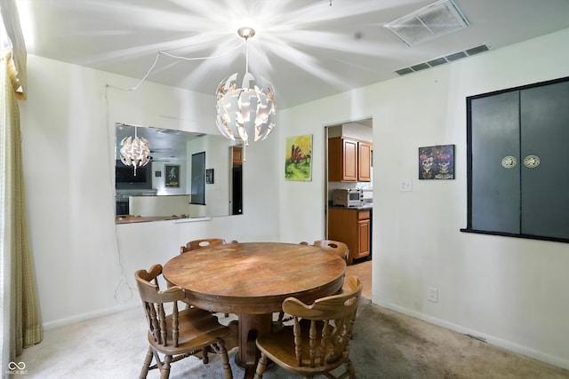 4340 Ashbourne Ln, Indianapolis, IN 46226 - dining room featuring a chandelier and light colored carpet